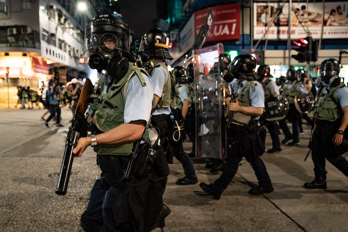 Hong Kong police patrol the street