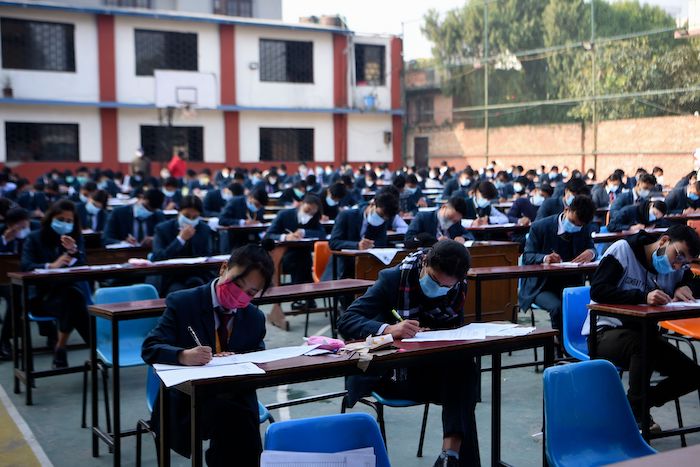 Students write exams outside in Nepal