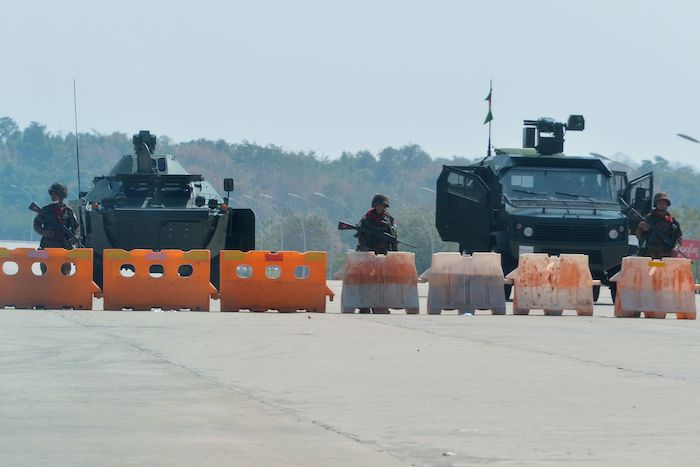 Troops in Myanmar block road to parliament in coup.