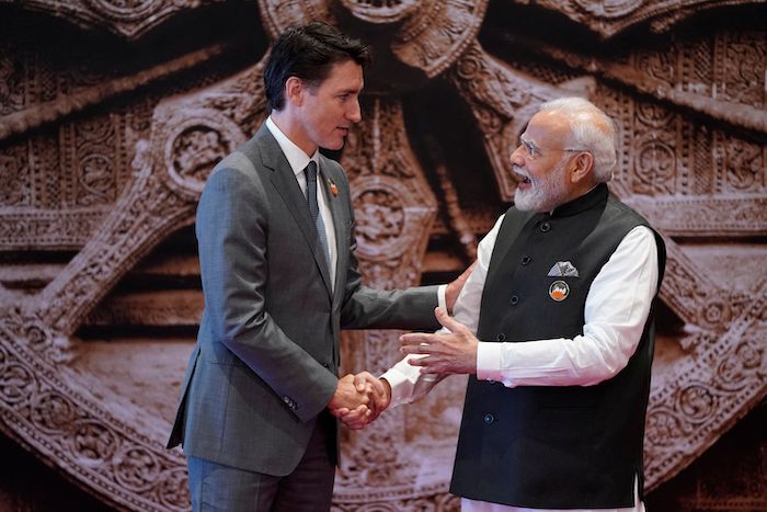 PMs Trudeau and Modi shake hands