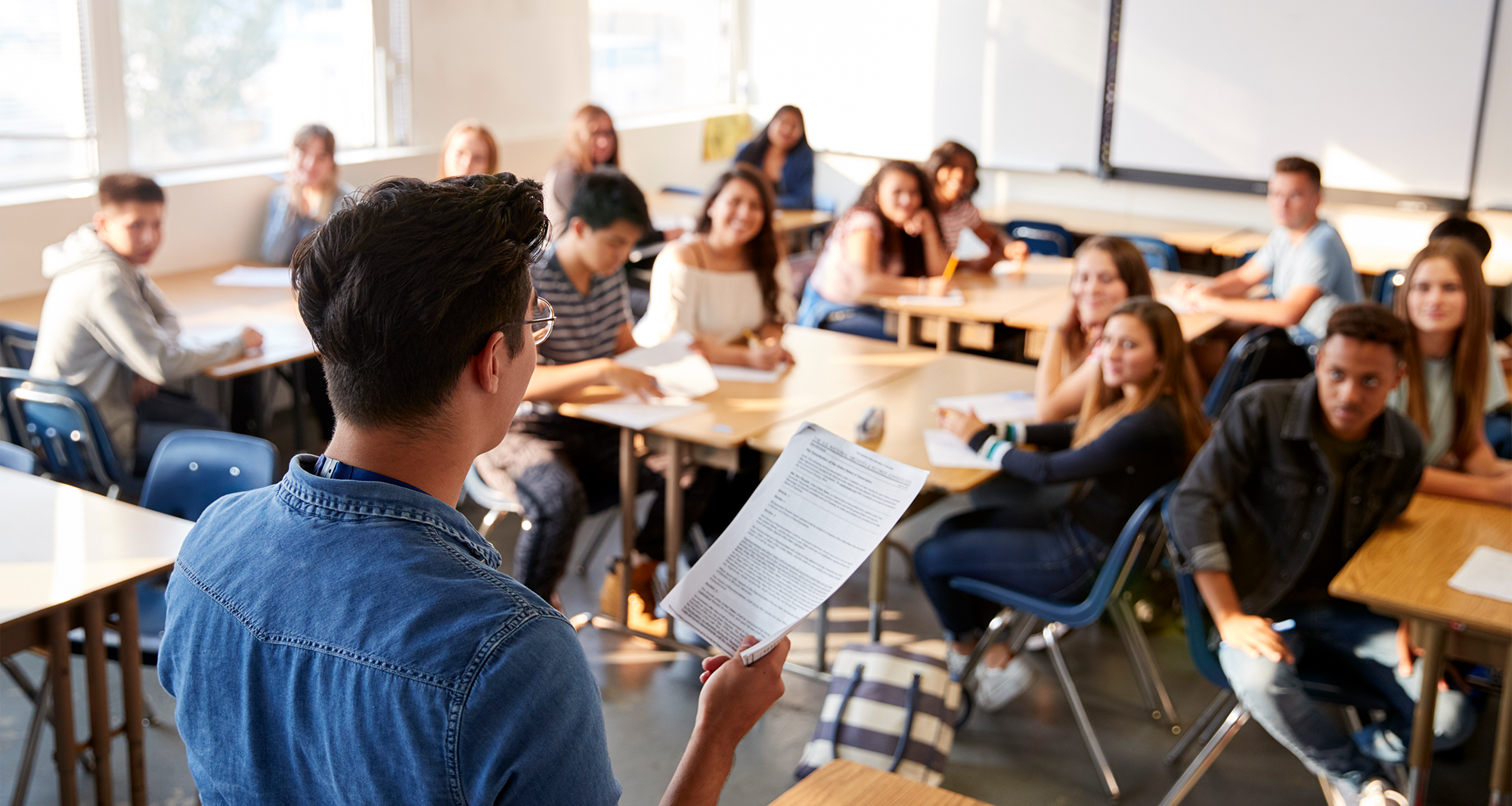 Teacher instructing high-school students