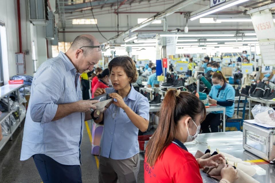 Timothy Stephen (left), director of product development, production and sourcing at Vessi Footwear Ltd., inspects the company's new collection at its manufacturing partner near Ho Chi Minh City, Vietnam. 