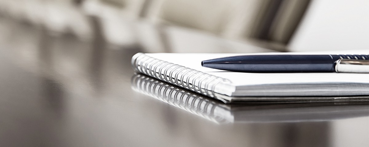 notebook and pen on conference table