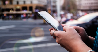Person reading information on mobile device