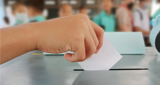 Young man casting a ballot