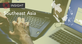 Man typing at multiple keyboards on banner image of Southeast Asia