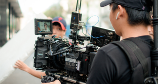 Photo of young men with a movie camera by Lê Minh