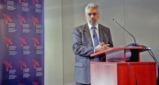 Raja Mohan at podium during presentation