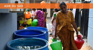 Woman carries water in Bengaluru