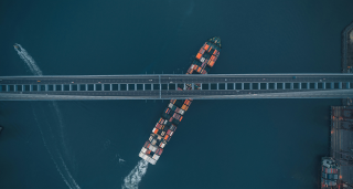 container ship beneath a bridge 