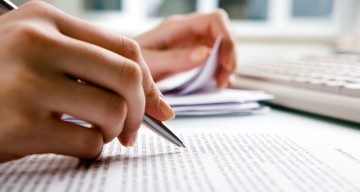 Researcher writing on a tablet 