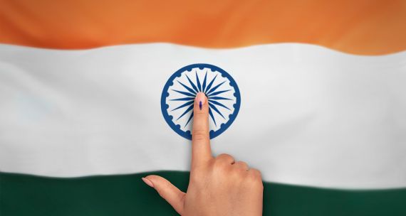 Voter with finger on flag of India