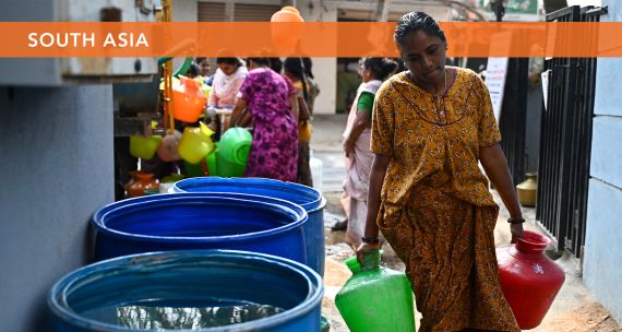 Woman carries water in Bengaluru