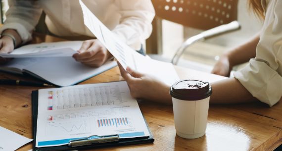 Meeting at a table with coffee and papers