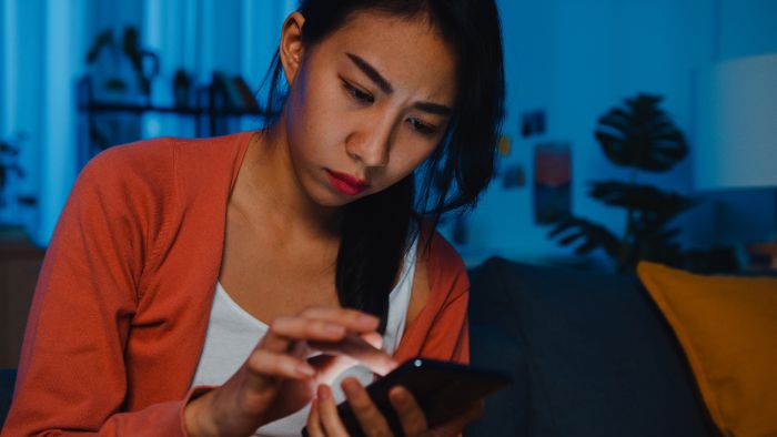 A woman checks her tech device