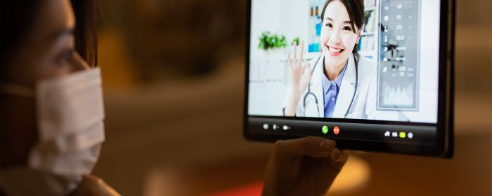 Close-up of woman looking at COVID doctor