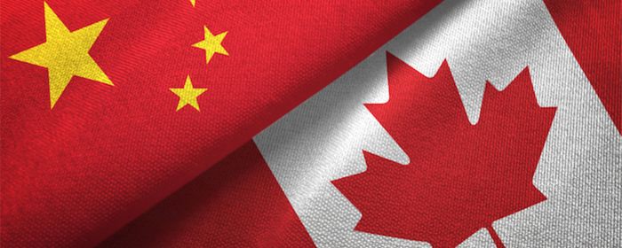 Canada and China flags folded together 