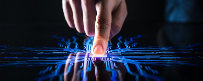 Hand pushes a quantum computer button 