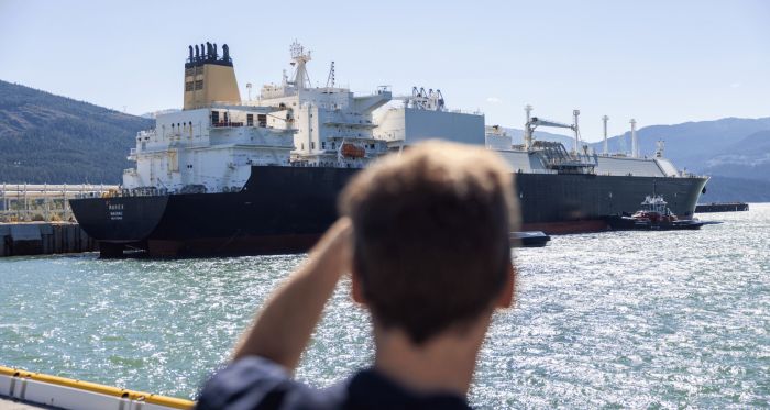 BC Premier David Eby in front of a Canadian LNG tanker 