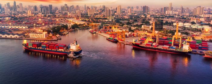 Container ships in harbour at sunset